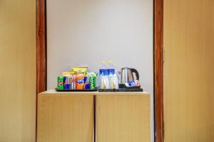 a cabinet with food and drinks on top of it at JS Residency Luxe Collection Hotel Near Nizamuddin Railway Station in New Delhi +53 photos
