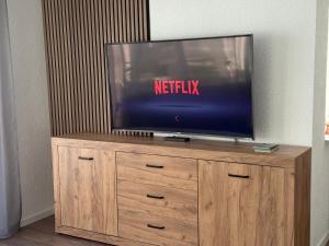 ラールにある120 m Penthouse, Europa Park -Rulantica- Straßburg - Colmar - Schwarzwald, bis 11 Personnenの木製エンターテイメントセンターの薄型テレビ