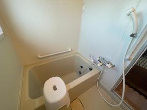 a bathroom with a toilet and a bath tub at Bear Foot 蒼 in Yakumo +21 photos