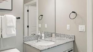 a bathroom with a sink and a mirror at Landing Apartments near North Fort Myers in North Fort Myers +46 photos