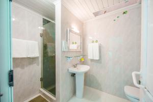 a bathroom with a sink and a shower at Casa do Cais in Calheta +40 photos