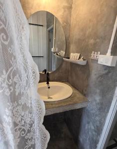 a bathroom with a sink and a mirror at มานอนนี่แคมป์ เขาค้อ in Khao Kho