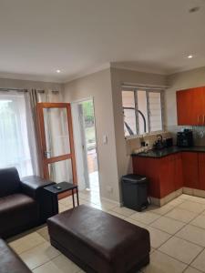 a living room with a couch and a kitchen at 1 Bedroom Luxury Apartment, Beacon Bay North, East London in East London