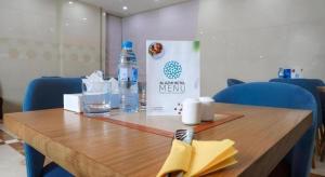 a wooden table with a bottle of water on it at ALAZMI HOTEL in Dubai