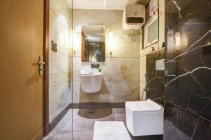 a bathroom with a toilet and a sink at JS Residency Luxe Collection Hotel Near Nizamuddin Railway Station in New Delhi