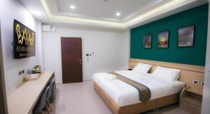 a bedroom with a large bed and a green wall at Aiyara Riverine Hotel, Nakhon Phanom in Ban Nong Puk +36 photos