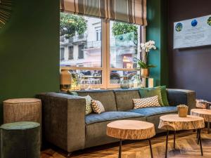 a living room with a couch and two tables at MADISON Saint Jean de Luz - Handwritten Collection in Saint-Jean-de-Luz