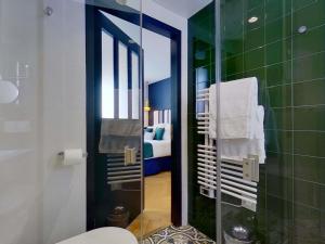 a bathroom with a toilet and a glass shower at MADISON Saint Jean de Luz - Handwritten Collection in Saint-Jean-de-Luz