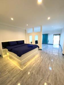 a bedroom with a bed and a wooden floor at Pun's Garden Home in Ban Sao Thong +47 photos