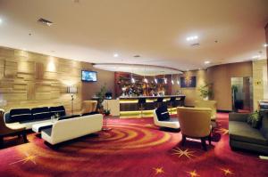a large living room with couches and chairs at Golden Tulip Galaxy Hotel Banjarmasin in Benuaanyar