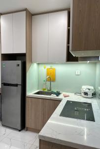 a kitchen with a sink and a refrigerator at BigSummer House in Long Bình