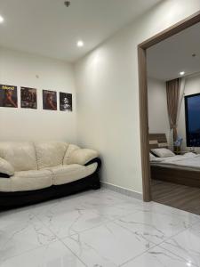 a living room with a couch and a mirror at BigSummer House in Long Bình