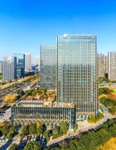 an aerial view of a tall building in a city at New Century Grand Hotel Hangzhou Zheshang in Yuhang