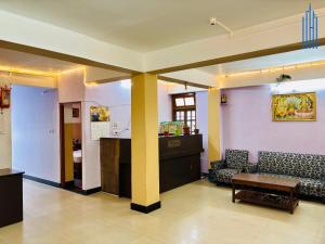 a living room with a couch and a table at Dhanishta Delight in Gangtok