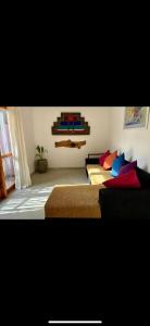 a bedroom with two beds with colorful pillows at The Little House in Hiriketiya