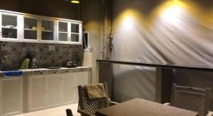 a kitchen with white cabinets and a table and chairs at Laverne Hotel in Ho Chi Minh City +63 photos