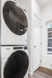 a microwave sitting on top of a washer and dryer at Privately Secluded Guesthouse in Fremont