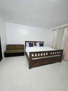 a bedroom with a bed and a couch at wombats beach resort,hotel, bar and restaurant in Olongapo