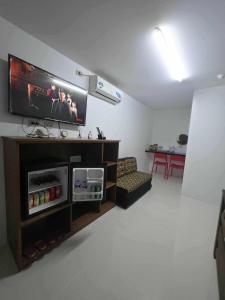 a living room with a flat screen tv on a wall at wombats beach resort,hotel, bar and restaurant in Olongapo