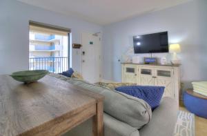 a living room with a couch and a tv at Verandas - 808 in Myrtle Beach
