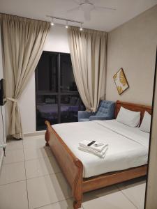 a bedroom with a bed and a blue chair at Trion Residence Kuala Lumpur by Centrix in Kuala Lumpur +22 photos