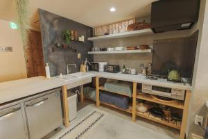 a kitchen with a sink and a counter top at La toile in Mitoyo