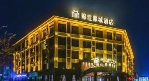 a building with lights on top of it at night at Jinjiang Metropolo Hotel - Liyang Tianmu Lake in Liyang