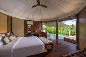 a bedroom with a large bed and a pool at The Wapa Lux Tent in Sidemen +33 photos