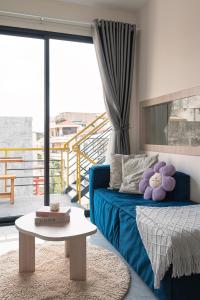 a living room with a blue couch and a table at DKA Balance in Ho Chi Minh City
