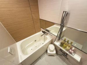 a bathroom with a white tub and a toilet at Hotel La'i ローレル Adult only in Tokyo