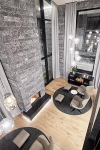 a living room with a brick wall and a fireplace at Chalet White Pearl by MYALPS in Sölden