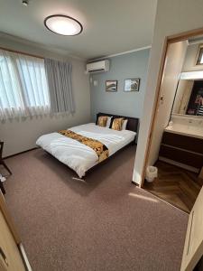 a bedroom with a bed and a large mirror at Yasuragi-KAWAGOE 2F in Kawagoe