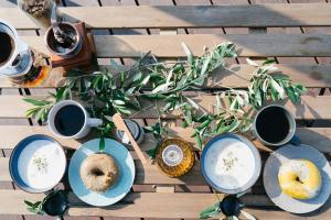 a table with plates of donuts and cups of coffee at La toile in Mitoyo +5 photos