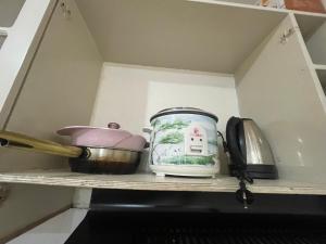 a kitchen shelf with a jar and a telephone at Harmony Transient in Baguio
