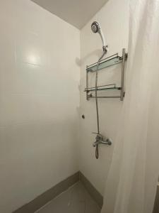 a shower in a bathroom with a shower curtain at Harmony Transient in Baguio