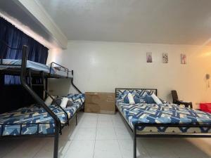 a room with three bunk beds in it at Harmony Transient in Baguio