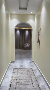a hallway with a room with a bed and a rug at alula apartment in Quai