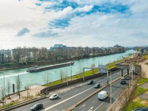 a river with cars on a highway next to a bridge at ibis Paris La Defense Courbevoie in Courbevoie