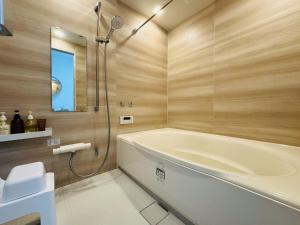 a bathroom with a tub and a toilet and a sink at Villa Blanche - Vacation STAY 31400v in Sumoto