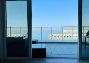 a living room with a view of the ocean from a glass door at Villa Blanche - Vacation STAY 31400v in Sumoto
