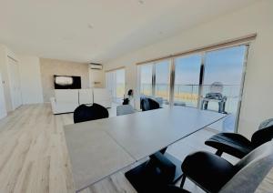 a living room with a large white table and chairs at Villa Blanche - Vacation STAY 31400v in Sumoto