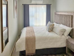 Ένα ή περισσότερα κρεβάτια σε δωμάτιο στο Tranquil Haven Suites +11 φωτογραφίες