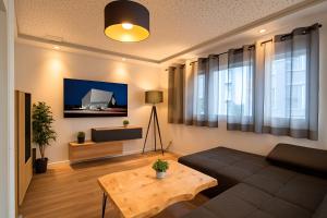 斯图加特Porschenahe Wohung的客厅里有一张沙发和一张桌子。