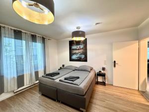 a bedroom with a large bed and a large window at Porschenahe Wohung in Stuttgart