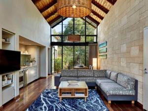a living room with a couch and a table at Pullman Bunker Bay Resort Margaret River in Dunsborough