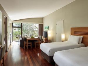 a hotel room with two beds and a dining room at Pullman Bunker Bay Resort Margaret River in Dunsborough +87 photos