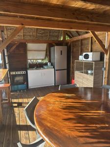 a wooden table and chairs in a kitchen with a table at Fare Vai Uteute in Uturoa +14 photos