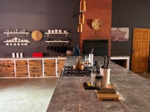 a kitchen with a large counter with a counter top at Big Cats Namibia Farmstays in Outjo +106 photos
