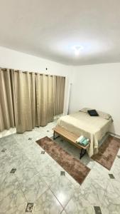 a bedroom with a bed and a table in it at Próximo a São Brás, Rodoviária e Supermercado! in Belém