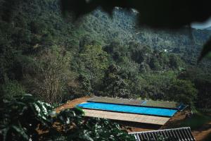 a swimming pool on the side of a mountain at Hidden for Rest in Ban Huai Khai